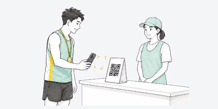 会場受付に設置されたQRコードを、ランナーがRuntripアプリで読み取っている。そばに受付スタッフ